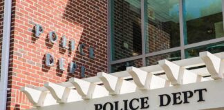 Police department entrance with pergola and brick wall