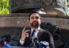Zohran Mamdani speaking at an outdoor press conference