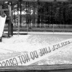 Playground closed off with caution tape in black and white
