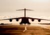 Large cargo aircraft on runway at sunrise