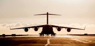 Large cargo aircraft on runway at sunrise
