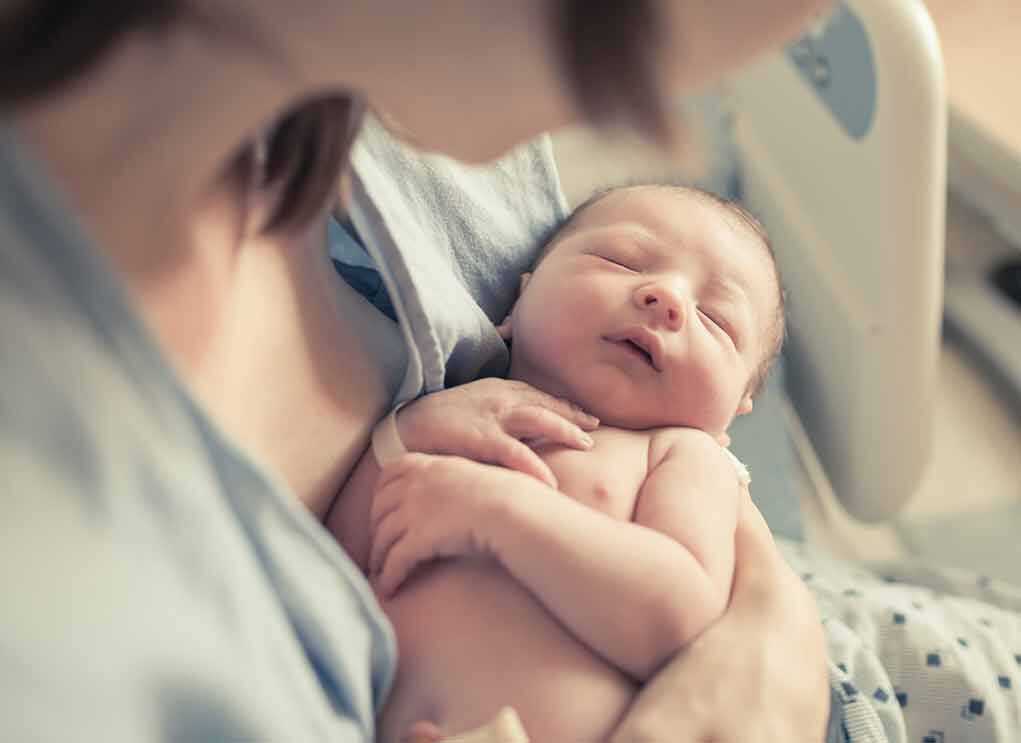Doctor Cleared in Toddler Euthanasia Case newborn baby sleeping in a parent's arms