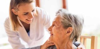 Caregiver smiling at an elderly woman