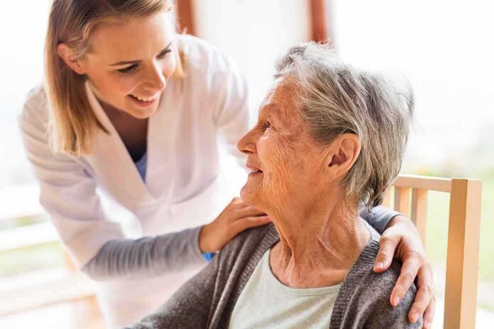 Caregiver smiling at an elderly woman