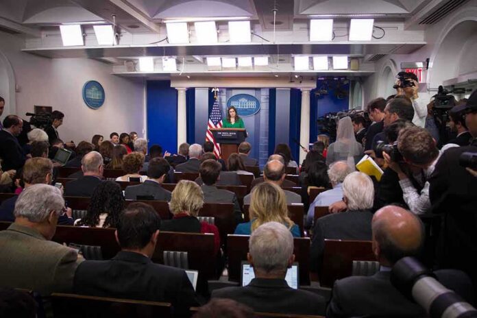 shutterstock_744405130 Omarosa Manigault, Jonathan Cyprien, and Jon Ledecky in a crowded White House press briefing
