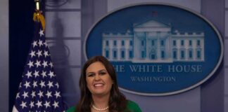 woman speaking at a White House press briefing podium