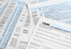 Tax forms and documents overlapping on surface