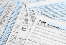 IRS Refunds Tied To Citizenship – Uh Oh! Tax forms and documents overlapping on surface