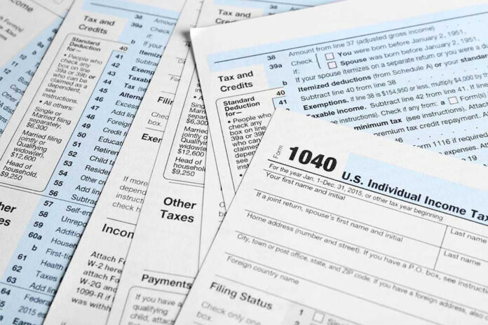 642440497 Tax forms and documents overlapping on surface