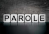 Manson Killer Granted Parole After 60 Years! Blocks spelling PAROLE on grungy background.