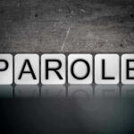 Blocks spelling PAROLE on grungy background.