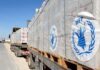 Humanitarian aid trucks loaded with palletized supplies