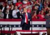 Boxing Legend Shocks Trump Rally Donald Trump points from a rally stage; Rudi Koertzen and Bear Pascoe are in the crowd
