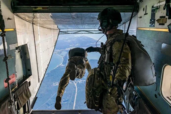 Paratroopers jump from a military aircraft over coastline