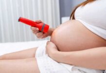Influencer Offers $200K to ABORT Babies! Pregnant woman shining flashlight on bare belly