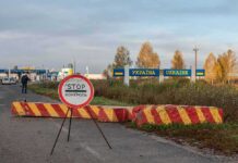 Drone Strikes Ukraine Nuclear Reactor Ukraine border crossing with stop sign and barrier