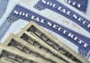 Social Security cards with U.S. dollar bills