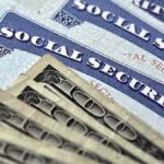 Social Security cards with U.S. dollar bills