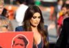 Kimberly Guilfoyle walking outdoors among a crowd
