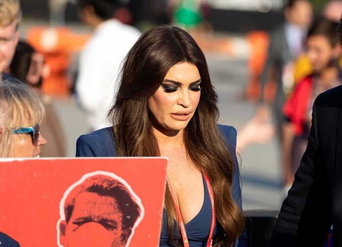 Kimberly Guilfoyle walking outdoors among a crowd