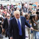 Trump Limp Sparks Viral Leg Rumor Donald Trump walks up steps through a crowd as A. J. Calloway films nearby