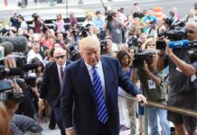 Trump Limp Sparks Viral Leg Rumor Donald Trump walks up steps through a crowd as A. J. Calloway films nearby