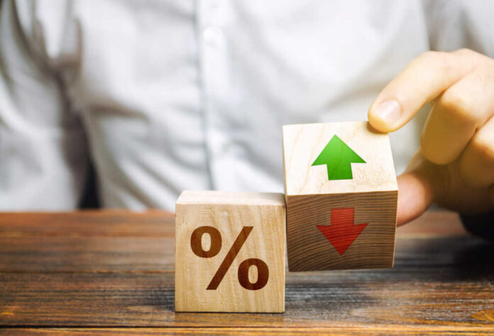 Businessman,Holds,Wooden,Blocks,With,Percent,And,Up,Or,Down