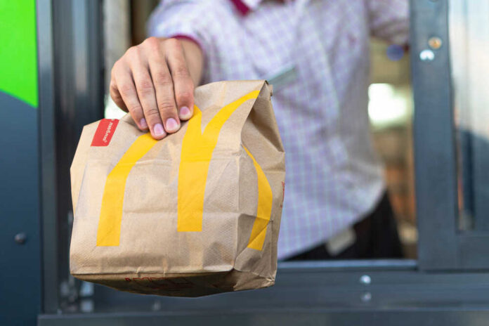 Sankt-petersburg/russia,-,July,21,2019:,Mcdonalds,Worker,Holding,Bag,Of
